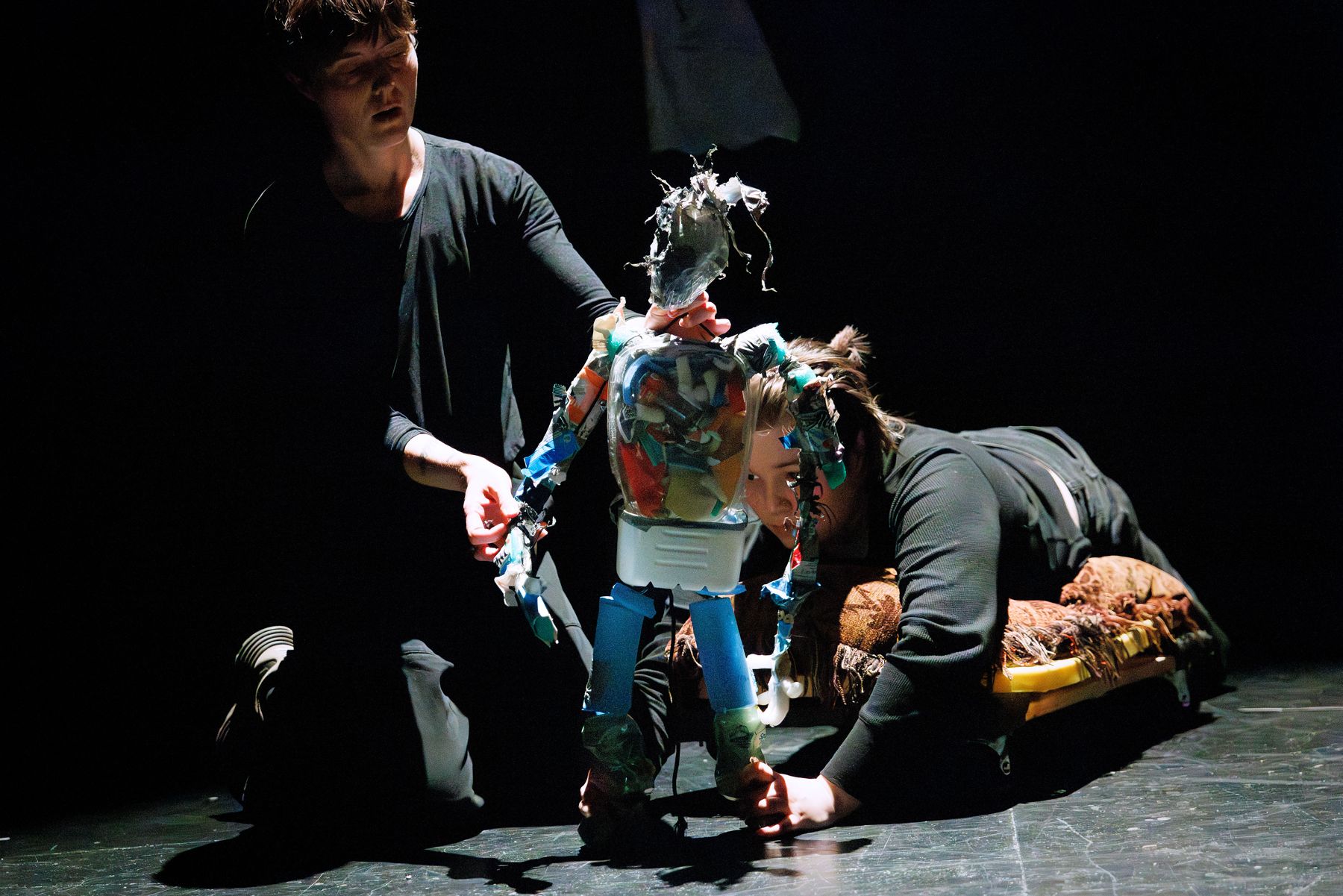 Puppeteers bring a trash puppet to life