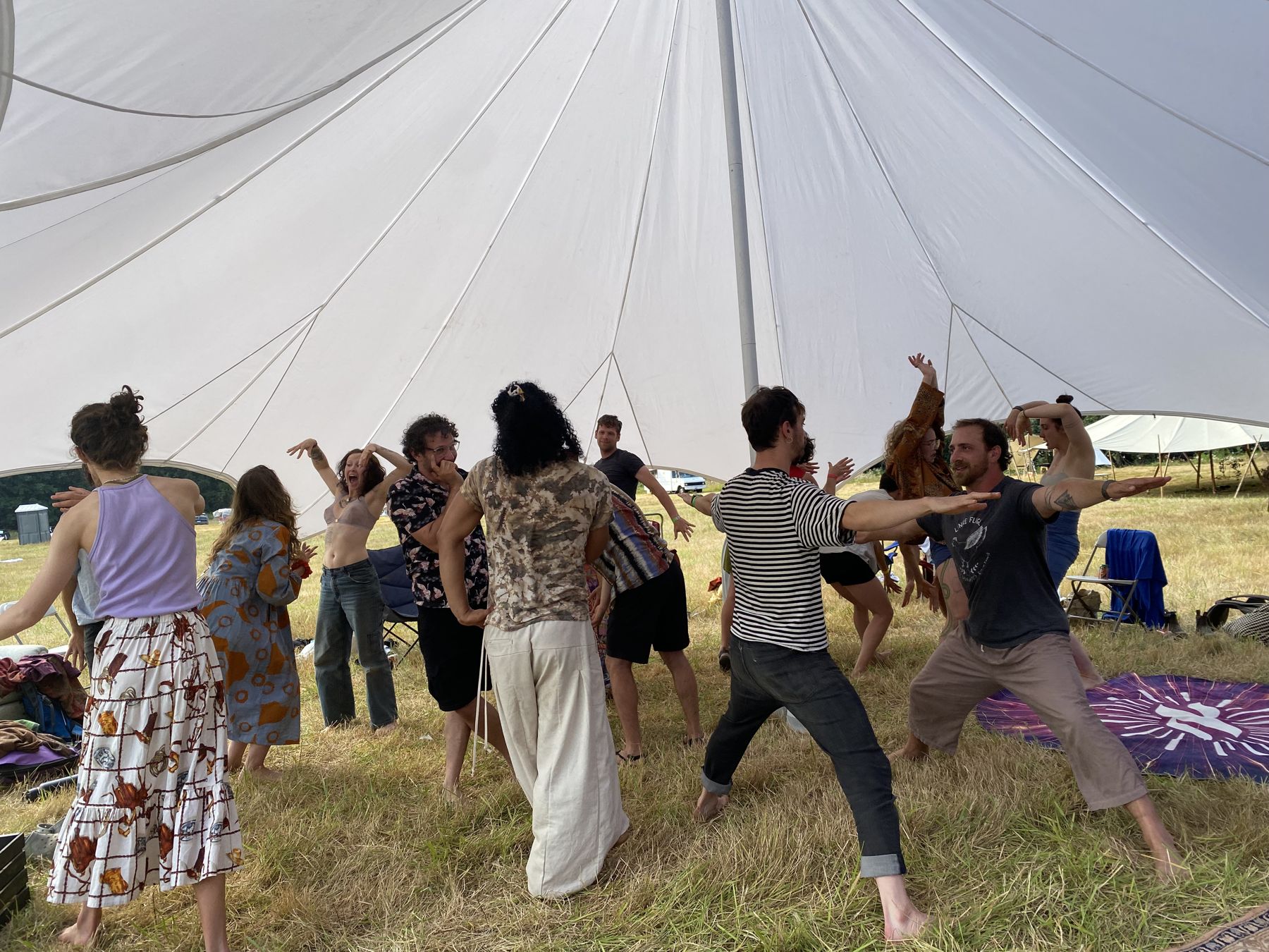 Participants moving under a large white canopy